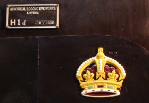 The gold royal crown above the cylinders, and builders plate